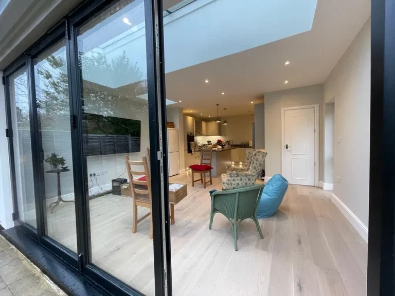 Modern rear home extension in Tulse Hill SW2 creating a bright open-plan living space with skylights and large sliding doors.