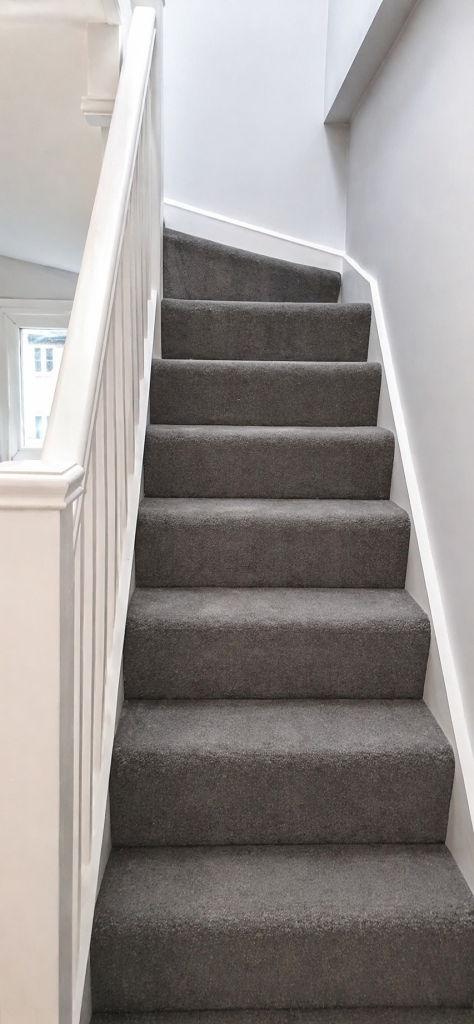 New staircase to loft conversion in Islington at Kingsdown Road N19 with grey carpet and white balustrade